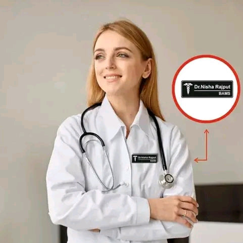 Doctor wearing a white coat with a stethoscope, standing against a neutral background.