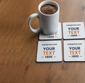 White mug with coffee on a wooden table with personalized coasters.